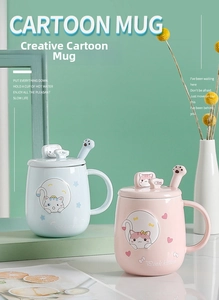 Detail of pink and blue ceramic cat mugs with matching paw spoons and embossed lids