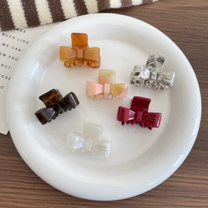 Elegant bow-shaped acetate hair claw clips in assorted colors for French style styling