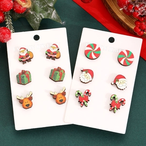 Christmas stud earring set featuring Santa, reindeer, and gift box designs on wood