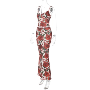 Detailed close-up of the red rose floral print on silky satin crop top and maxi skirt set