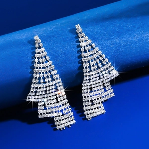Detailed view of silver geometric fringe earrings with sparkling rhinestone crystals