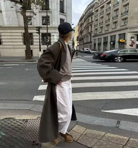Street style view of a long oversized dark brown double-breasted wool coat for women