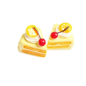 Miniature resin triangle cake model with cream, cherry, and lemon slice decorations