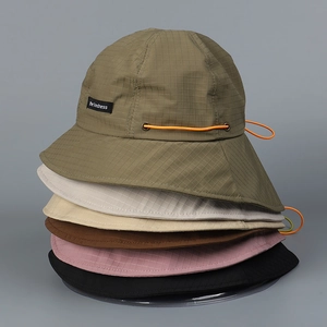 Detailed stack of multi-color nylon sun hats with adjustable toggles and wide brims