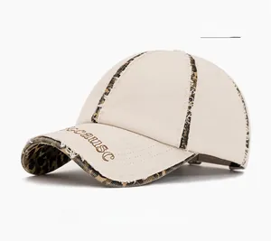 Detail of frayed edge baseball cap with leopard print stitching and embroidered text