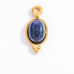 Macro detail of French vintage 18k gold plated lapis lazuli stone jewelry pendant
