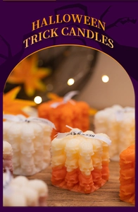 Close-up of stacked skull pumpkin Halloween candles in orange and off-white colors