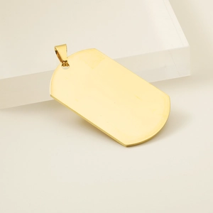 Close-up of polished golden stainless steel dog tag pendant with smooth mirror finish