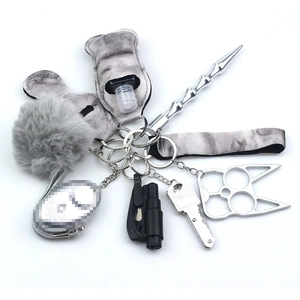 Detailed set featuring tie-dye neoprene pouches, grey pom-pom, and metal utility keychains