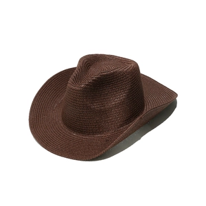 Detailed weave texture of a dark brown straw cowboy hat with a classic pinched crown