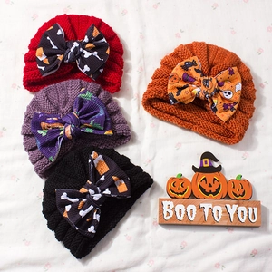 Halloween baby knitted hats with festive bows featuring pumpkin and ghost patterns