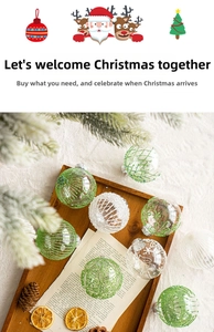 Detail of transparent Christmas ball with green glitter lines and white snowflake patterns