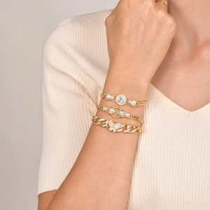 Gold layered bracelet set featuring leopard heads, butterfly charm, and cubic zirconia