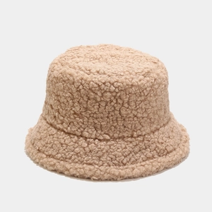 Close-up of beige sherpa fleece texture on a thick minimalist bucket hat for winter