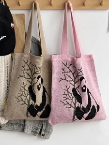 Detail of knitted panda tote bags in beige and pink with cute bamboo pattern