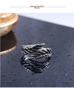 Detailed macro view of vintage angel wing feather ring in aged silver finish
