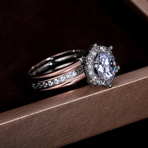 Macro detail of two-piece wedding ring set with six-prong round zircon in rose gold