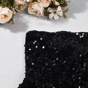 Close-up of black leopard print sequins and fabric texture on a sexy cropped top