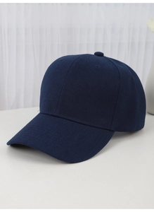 Detailed close-up of a navy blue cotton twill baseball cap on a clean white surface