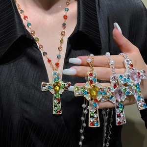 Cross pendant necklace with heart gemstone and tassels featuring vibrant rhinestones