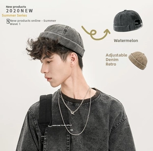 Detail of adjustable strap and washed denim texture on a retro grey docker cap