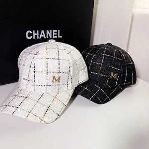 Women's tweed baseball cap with gold M logo in elegant black and white colors