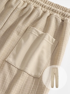 Macro shot of men's cargo pants showing waffle textured fabric and pocket stitching detail