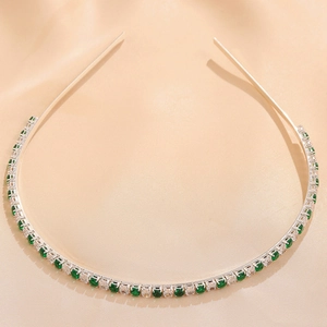 Detail of silver headband with emerald green and white square cut zircon stones