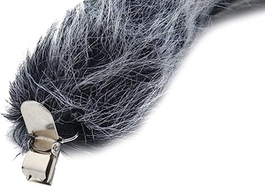 Detailed close-up of grey and black faux fur animal tail with a secure silver metal clip