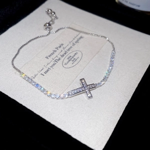 Detailed macro view of the silver cross bracelet with shimmering zircon stones and slider