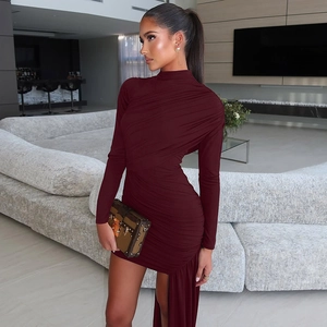 Detail view of burgundy ruched long sleeve dress with high neck and asymmetrical hemline