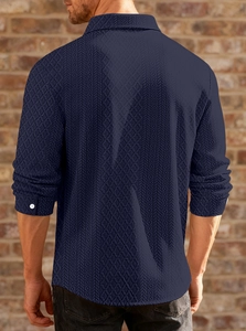 Macro detail of navy blue waffle texture fabric on man's long sleeve polo shirt back