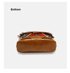 Detailed bottom view of Bohemian woven tote bag with durable brown faux leather and tassels