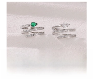 Detail of titanium steel spiral snake ring featuring a pear-shaped green gemstone