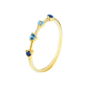 Elegant gold ring with gradient blue zircons set on a slim band over white background