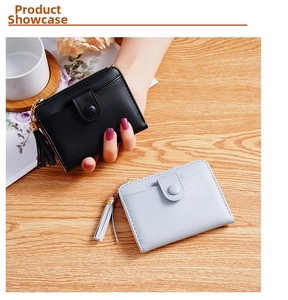 Detail of compact PU leather wallets in black and blue with tassel zipper and snap button