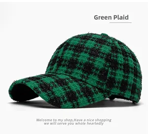 Close-up of green grid pattern and thick tweed texture on winter baseball cap