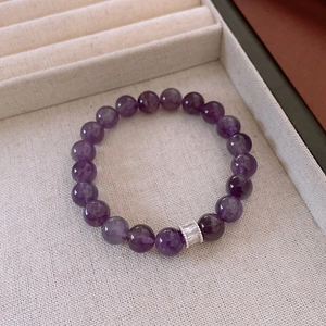 Detailed macro view of purple crystal beaded bracelet with silver zircon-set divider bead