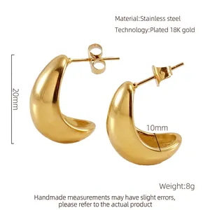 Detail of 18K gold plated C-shaped chunky earrings measuring 20mm with polished finish