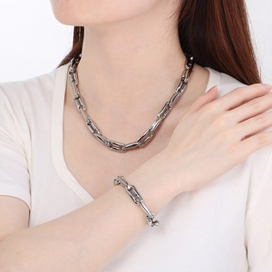 Close-up of polished 10mm pig nose chain necklace and bracelet set on a model