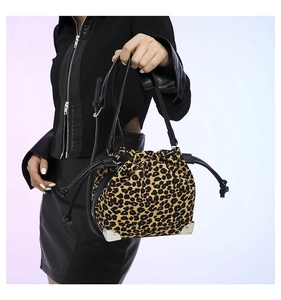 Close-up of leopard print bucket bag with silver metal corners and black drawstring