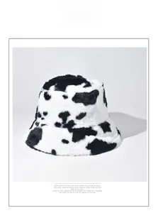 Close-up of soft faux fur texture on this black and white cow print bucket hat