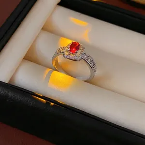 Elegant silver open ring with red oval zircon center stone and pave diamond accents