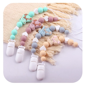 Set of four silicone pacifier clips with teddy bear and heart beads in pastel colors