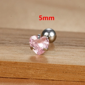 Macro shot of 5mm pink heart-shaped zirconia stud earring with screw back on wood