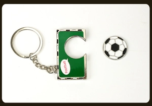 Detail view of green metal football keychain with enamel finish and soccer ball charm
