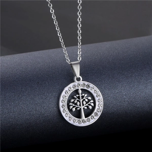 Detailed macro view of silver Tree of Life pendant with sparkling crystals on a chain