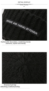 Detail of black knitted beanie showing unique fabric texture and a side patch logo