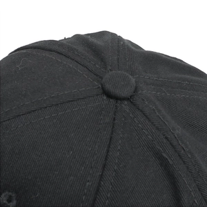 Detailed macro view of black cotton baseball cap crown with stitched top button