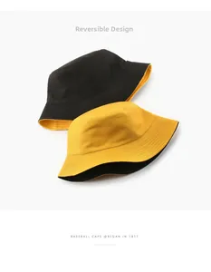 Detail showing reversible bucket hat in black and yellow with reinforced brim stitching